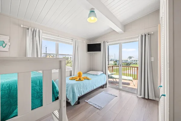 a bedroom with furniture and large windows