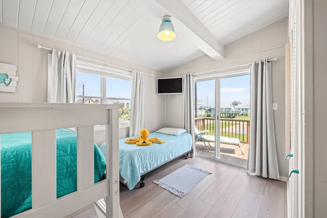 a bedroom with furniture and large windows