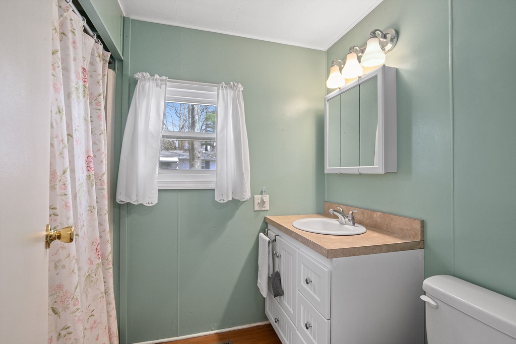 58 Bally Drive Raynham, MA 02767 - Photo 5 of 9 a bathroom with a sink and a mirror