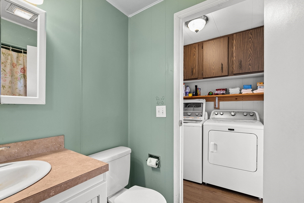 58 Bally Drive Raynham, MA 02767 - Photo 6 of 9 a bathroom with a toilet a sink and a mirror