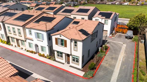 an aerial view of a residential apartment building with a mountain in the background