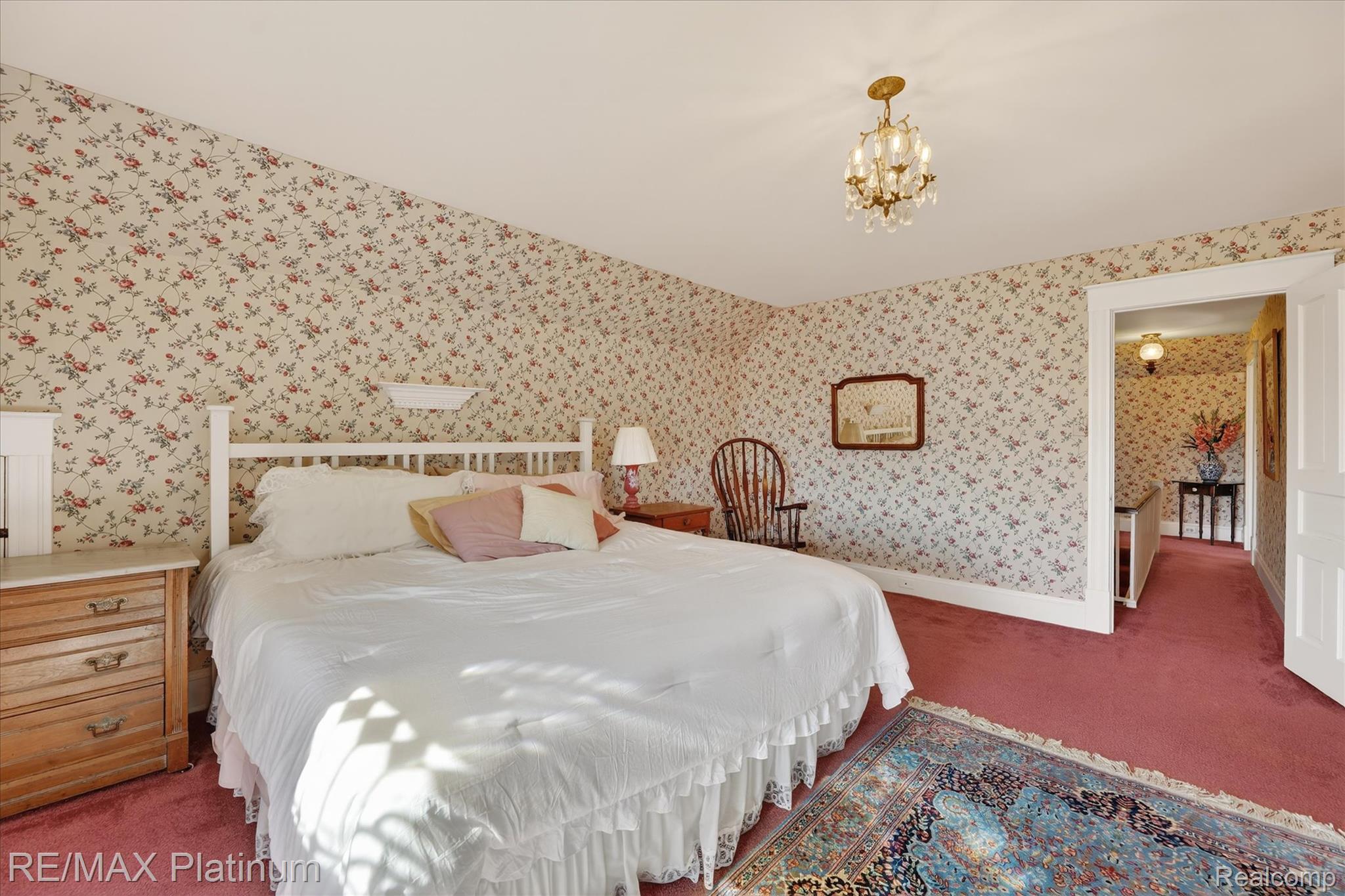 15330 Howlett Road Gregory, MI 48137 - Photo 14 of 26 Carpeted bedroom featuring a chandelier and baseboards