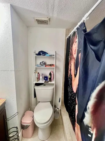 a bathroom with a sink vanity mirror and toilet