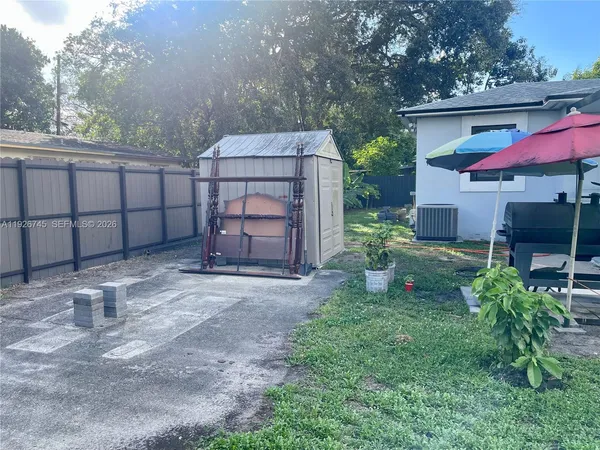 a backyard of a house with table and chairs