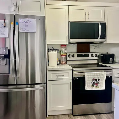 a kitchen with stainless steel appliances a refrigerator stove and microwave