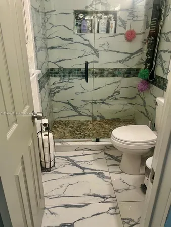 a bathroom with a toilet and a shower