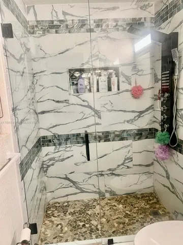 a bedroom with a bed and a wooden floor