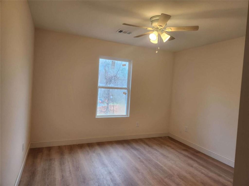 60 Reeves And Norrell Road Dawsonville, GA 30534 - Photo 6 of 11 wooden floor in an empty room with a window