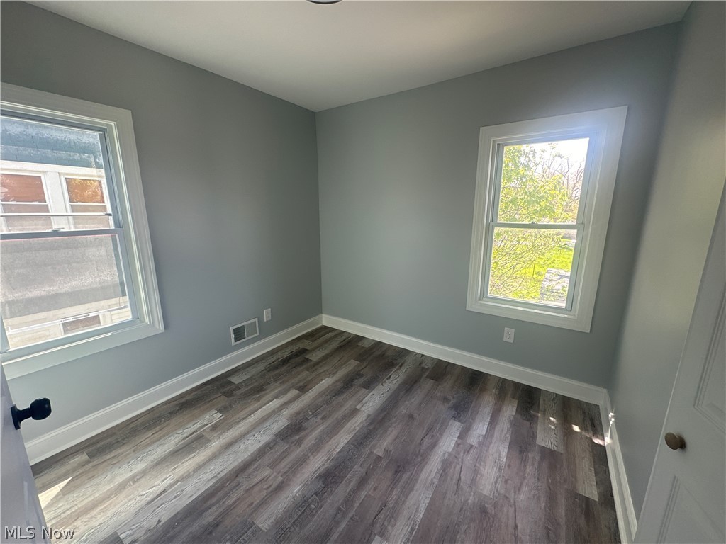 3550 Menlo Road Cleveland, OH 44120 - Photo 13 of 22 Unfurnished room with a healthy amount of sunlight and dark wood-type flooring