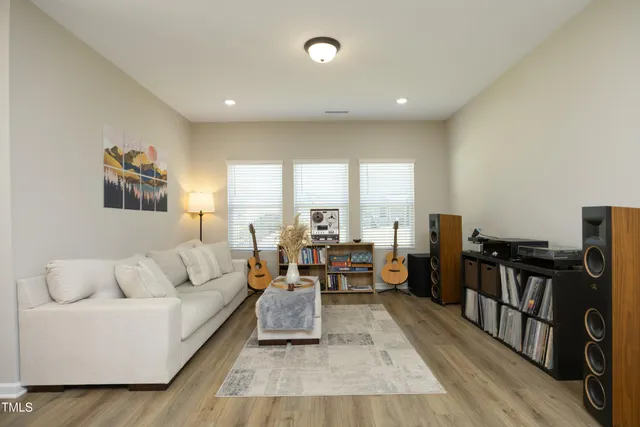 a living room with furniture flat screen tv and a table