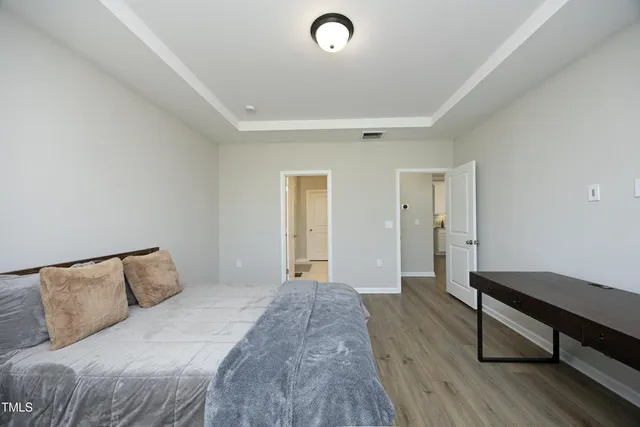 a bedroom with a bed and a dresser