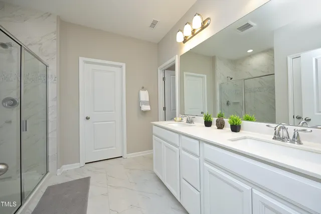 a bathroom with a double vanity sink and a mirror