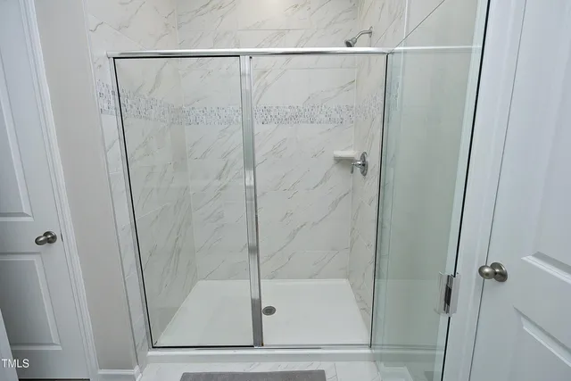 a bathroom with a glass shower door