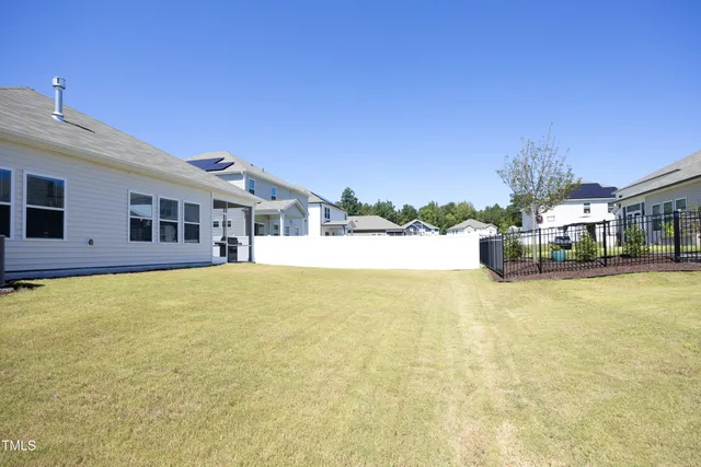 a swimming pool with outdoor seating and yard