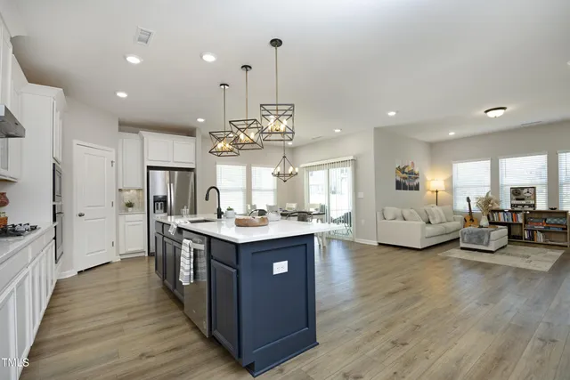 a kitchen with sink stove and cabinets