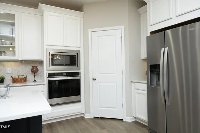 a kitchen with stainless steel appliances a refrigerator stove and sink