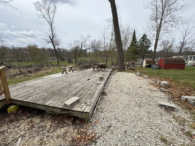a wooden bench sitting in the middle of a yard