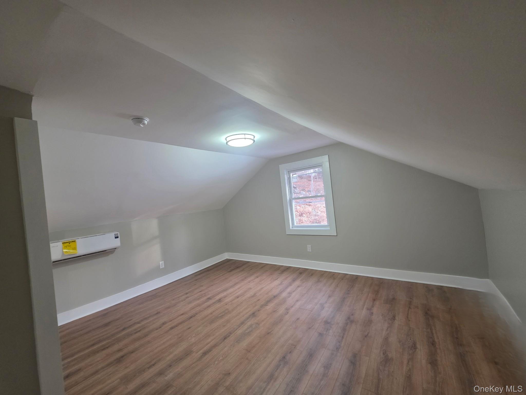 263 South Mountain Road New City, NY 10956 - Photo 24 of 33 Bonus room featuring wood finished floors, vaulted ceiling, and an AC wall unit