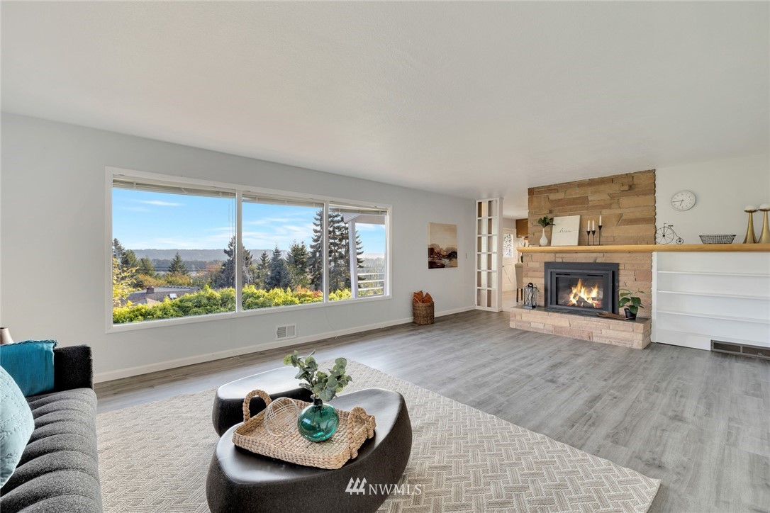 11409 Karshner Road East Edgewood, WA 98372 - Photo 3 of 28 a living room with furniture and a fireplace