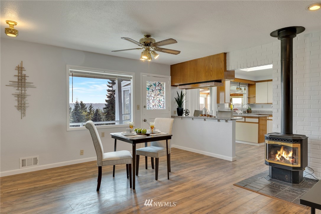 11409 Karshner Road East Edgewood, WA 98372 - Photo 23 of 28 a view of a dining room with furniture and wooden floor