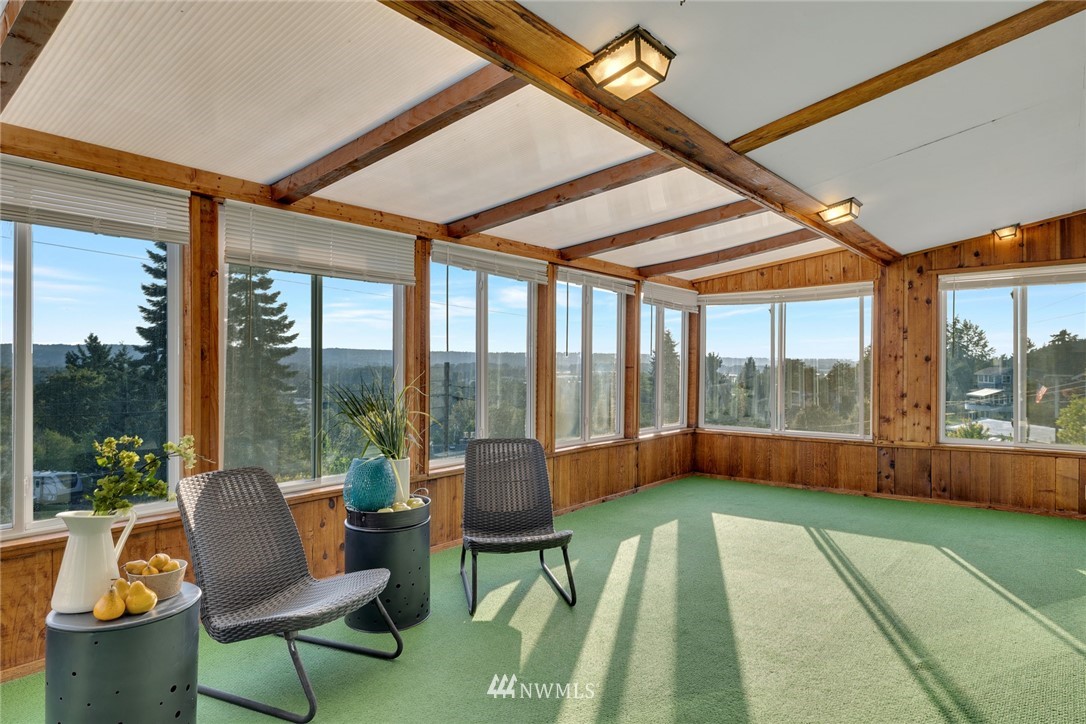 11409 Karshner Road East Edgewood, WA 98372 - Photo 7 of 28 a living room with a floor to ceiling windows and a table