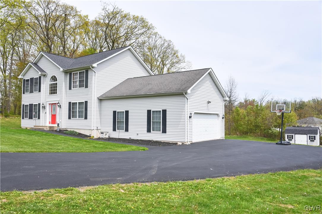 968 Renaldi Road Wind Gap, PA 18091 - Photo 3 of 18 a view of a white house next to a yard and large trees