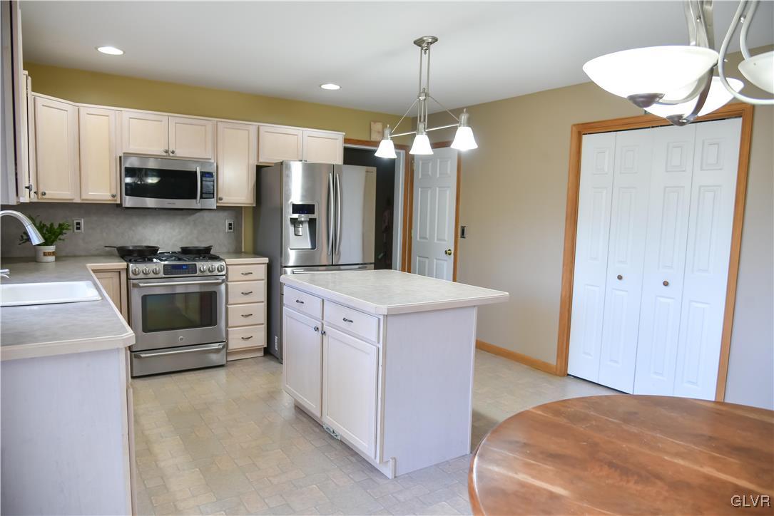 968 Renaldi Road Wind Gap, PA 18091 - Photo 7 of 18 a kitchen with stainless steel appliances kitchen island granite countertop a stove a sink and a refrigerator