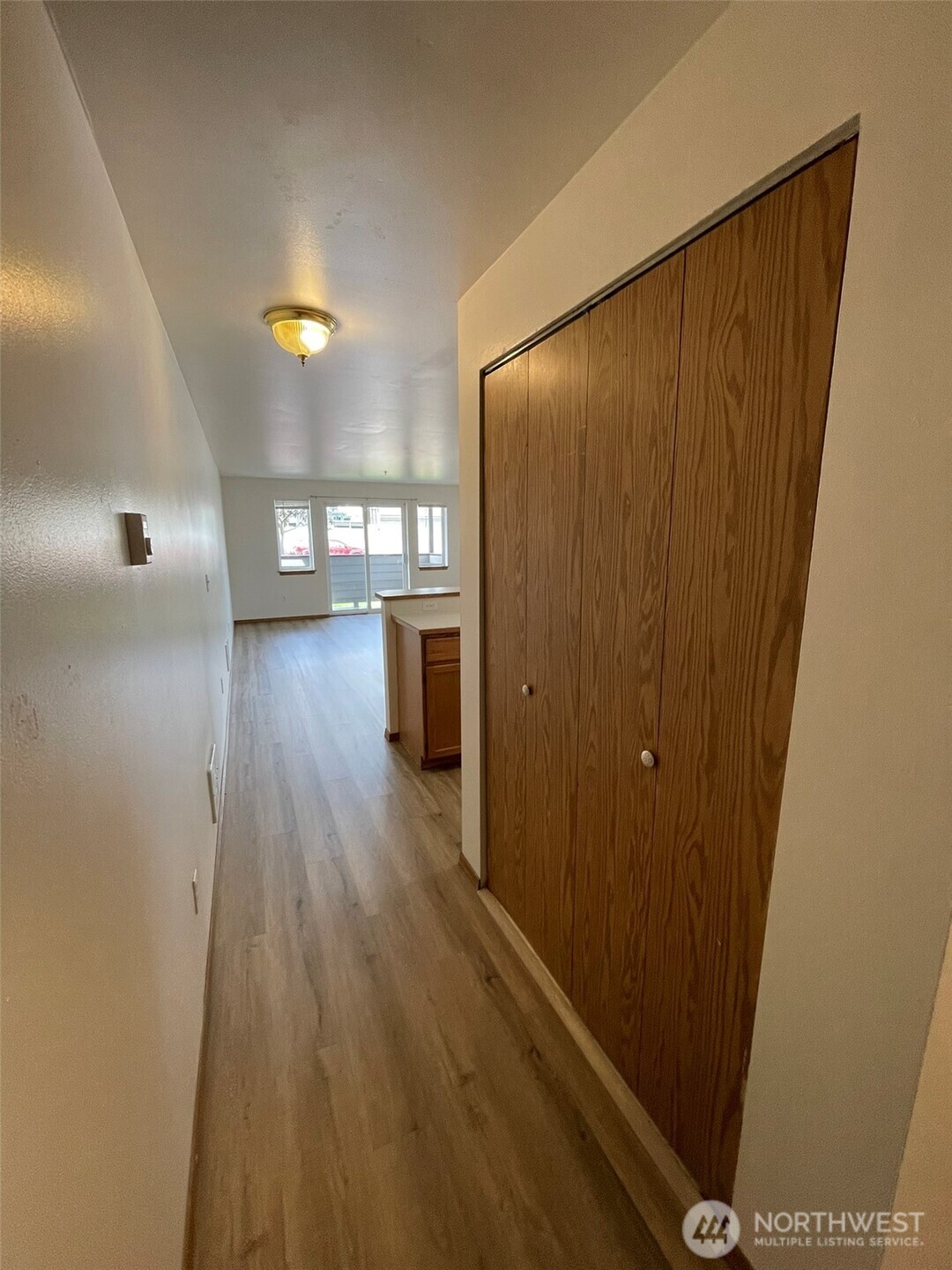 8830 Nesbit Avenue North Seattle, WA 98103 - Photo 12 of 32 a view of a hallway with wooden floor
