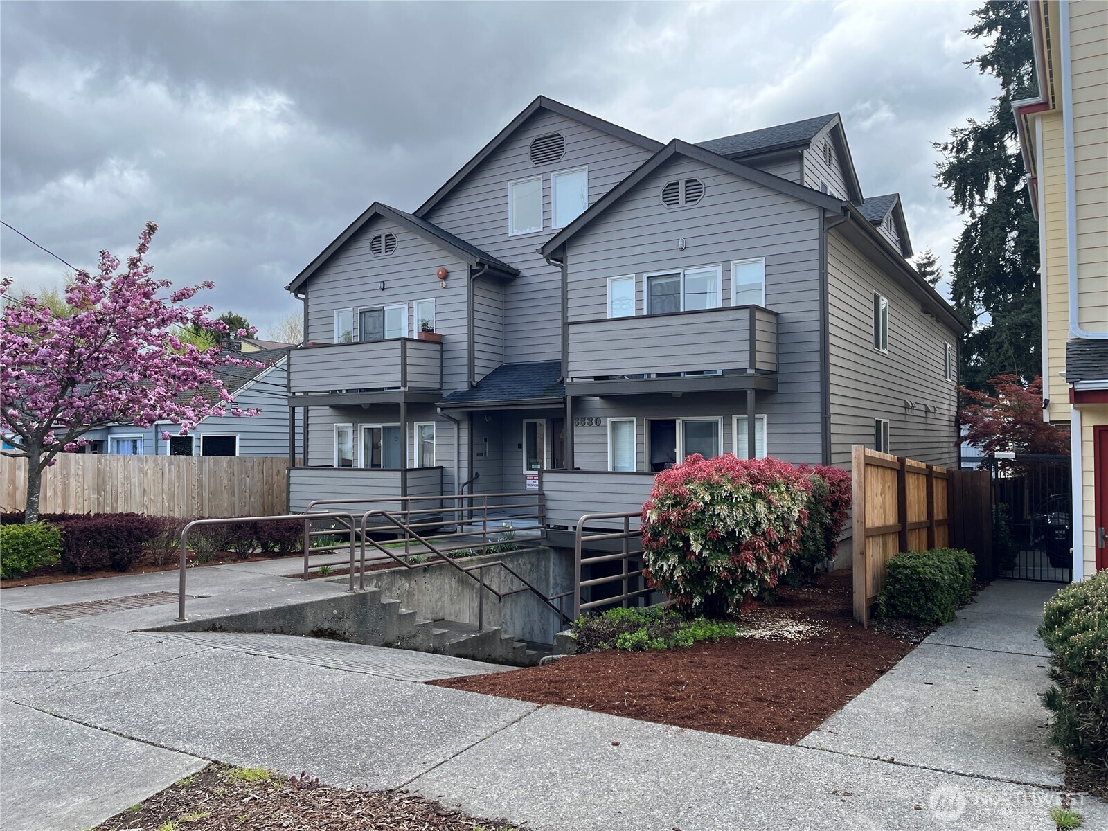 8830 Nesbit Avenue North Seattle, WA 98103 - Photo 2 of 32 a front view of a house with a yard and potted plants
