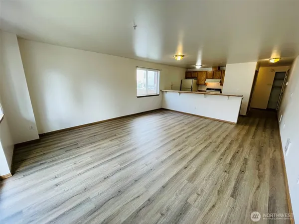 a view of a room with wooden floor
