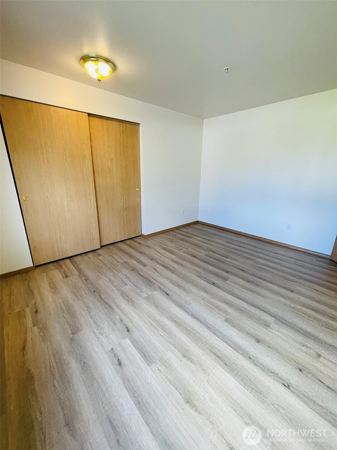8830 Nesbit Avenue North Seattle, WA 98103 - Photo 25 of 32 a view of an empty room with wooden floor