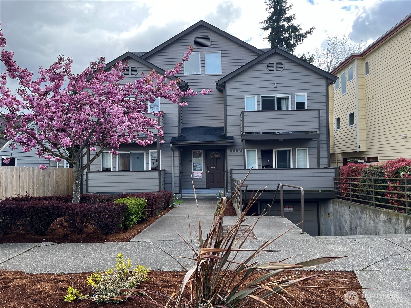 8830 Nesbit Avenue North Seattle, WA 98103 - Photo 3 of 32 a front view of a house with a yard and a garage
