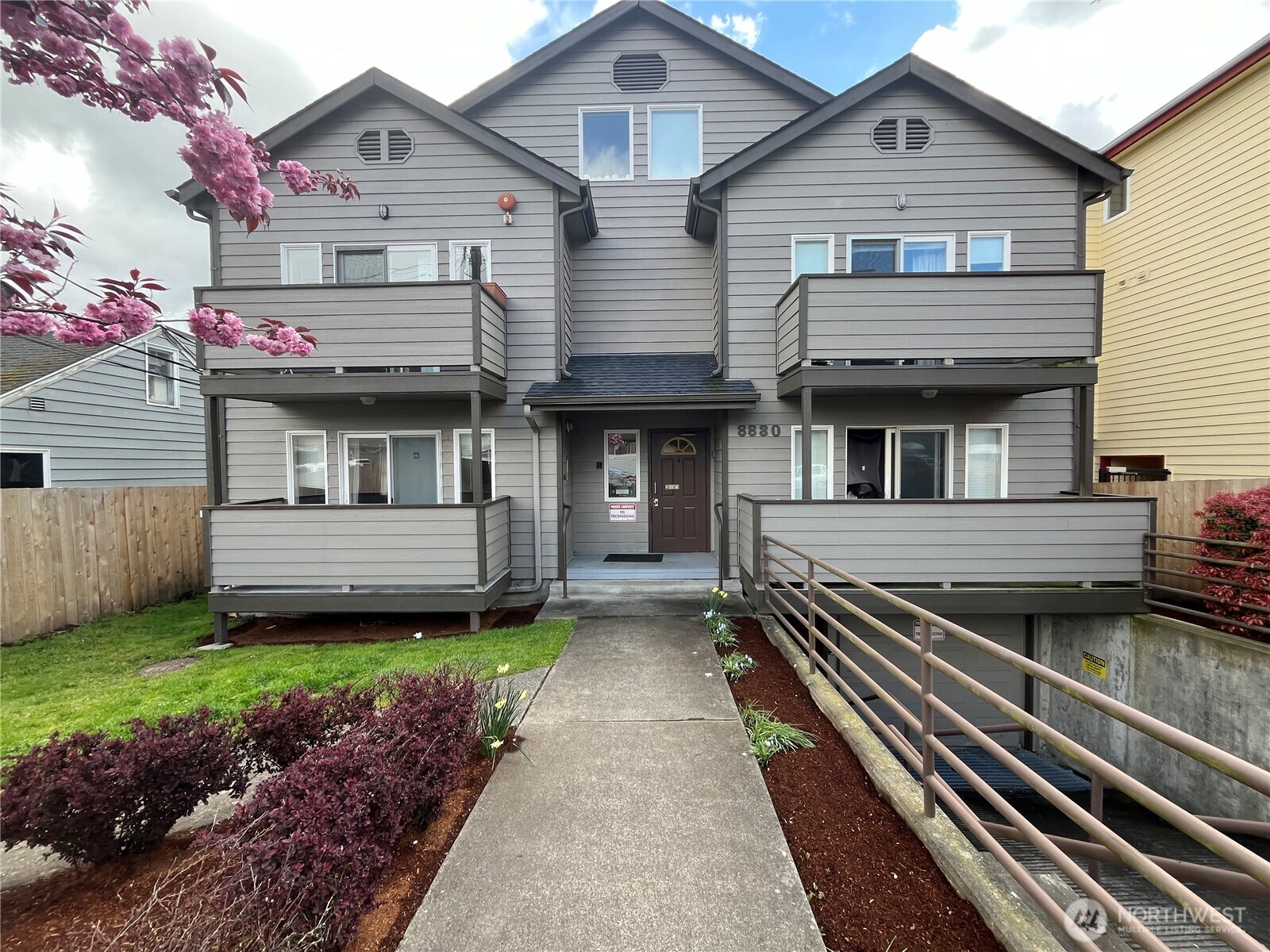 8830 Nesbit Avenue North Seattle, WA 98103 - Photo 6 of 32 a front view of a house with a garden