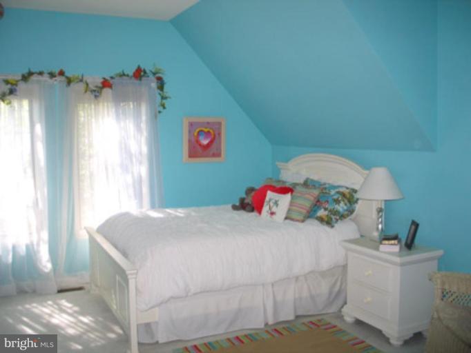 11591 Greenwich Point Road Reston, VA 20194 - Photo 12 of 30 a bedroom with a bed and a chandelier