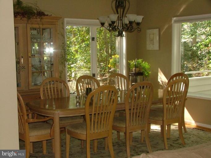 11591 Greenwich Point Road Reston, VA 20194 - Photo 6 of 30 a view of a dining room with furniture and chandelier