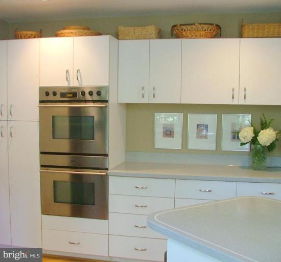 11591 Greenwich Point Road Reston, VA 20194 - Photo 8 of 30 a kitchen with white cabinets and appliances