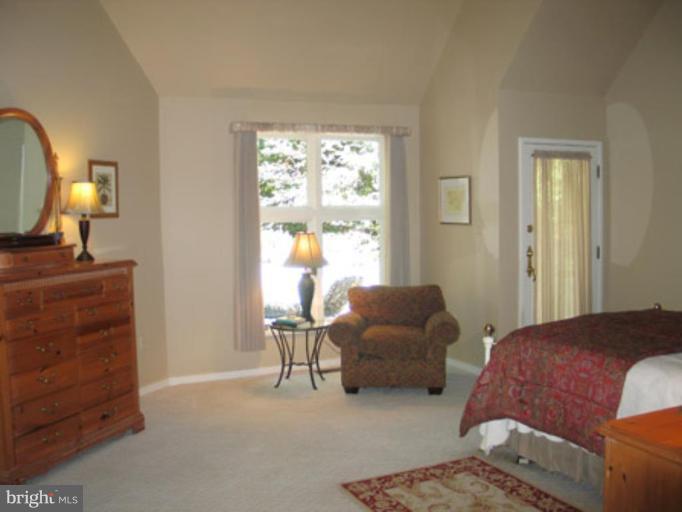 11591 Greenwich Point Road Reston, VA 20194 - Photo 10 of 30 a bedroom with furniture and a lamp