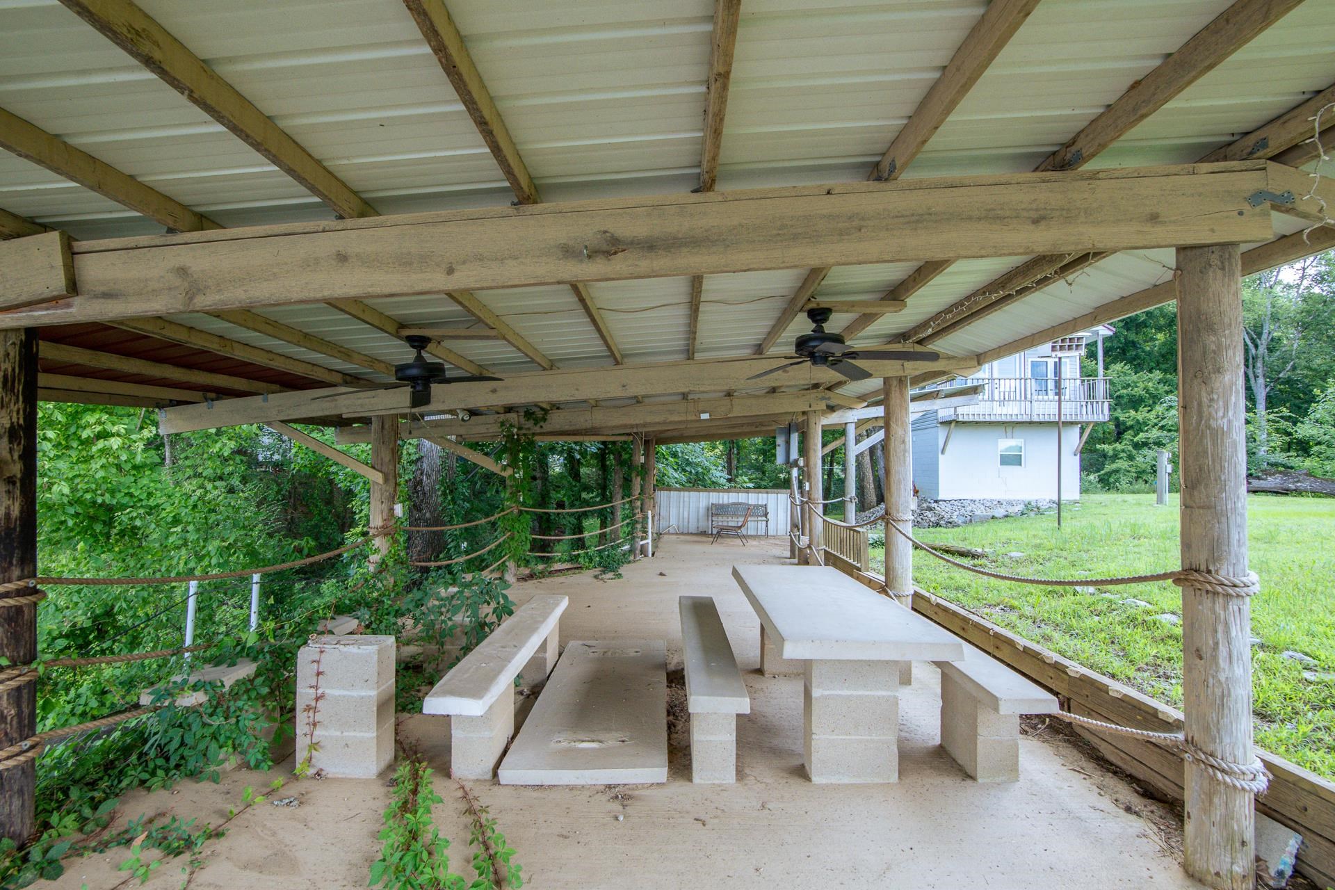 3360 Coffee Landing Road Morris Chapel, TN 38361 - Photo 22 of 36 a view of a patio with a table and chairs under a umbrella