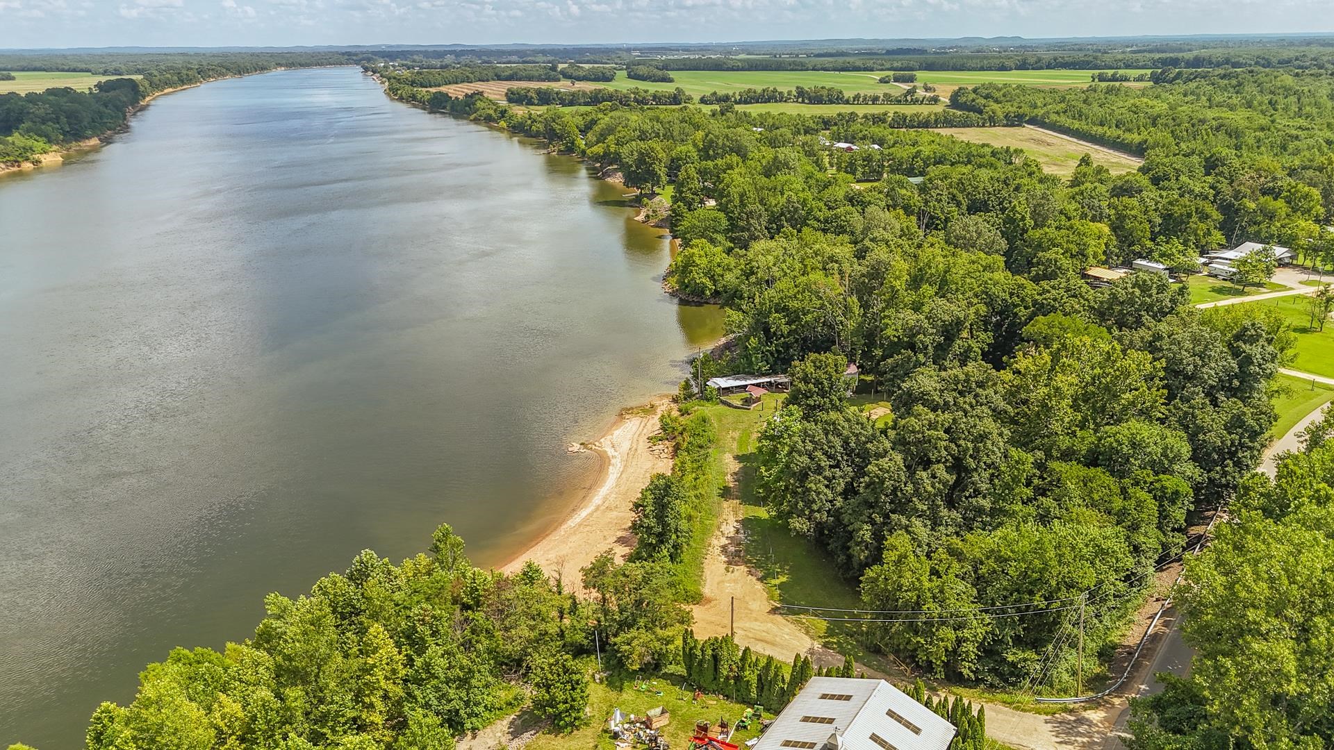 3360 Coffee Landing Road Morris Chapel, TN 38361 - Photo 32 of 36 a view of a lake with a yard