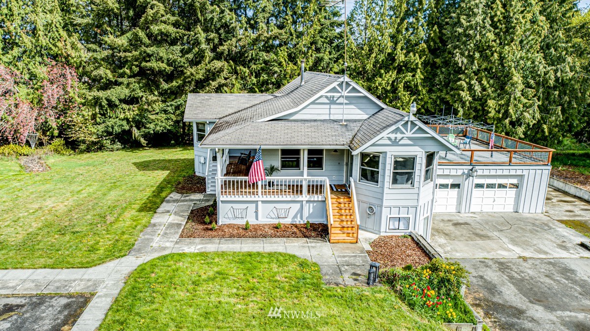 155 Taylor Cutoff Road Sequim, WA 98382 - Photo 1 of 37 a view of a house with a yard patio and a garden