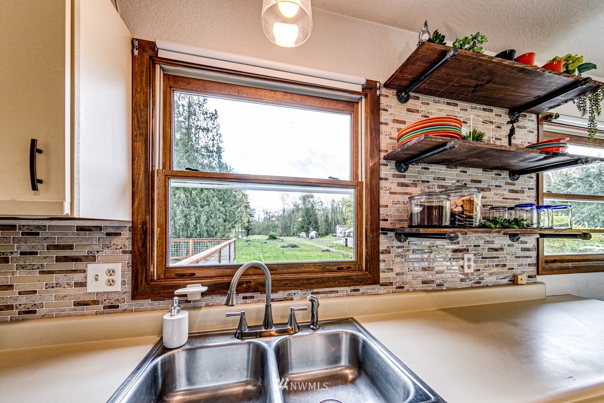155 Taylor Cutoff Road Sequim, WA 98382 - Photo 11 of 37 a kitchen with a sink and a stove