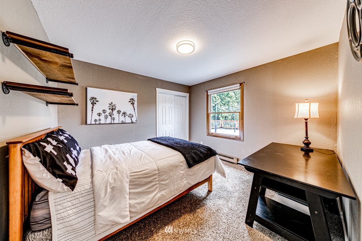 155 Taylor Cutoff Road Sequim, WA 98382 - Photo 13 of 37 a bedroom with a bed and a desk