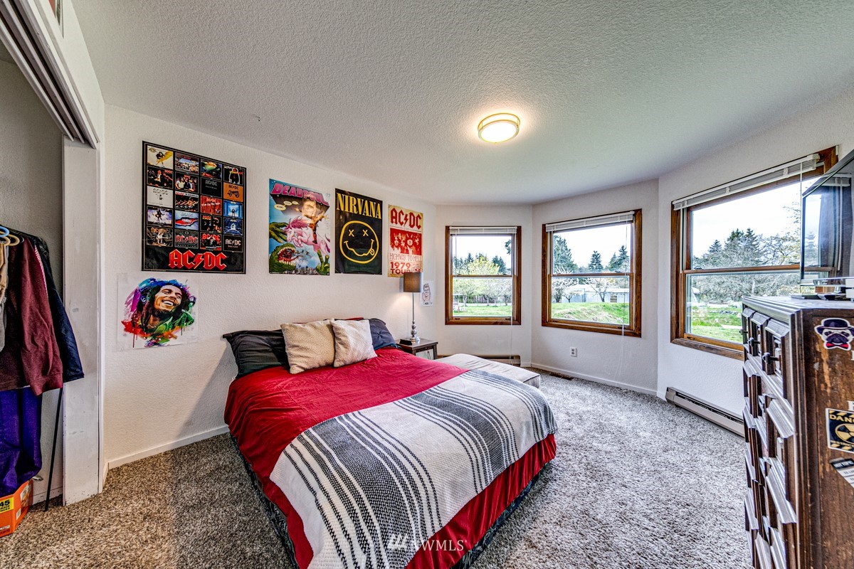 155 Taylor Cutoff Road Sequim, WA 98382 - Photo 15 of 37 a bedroom with a bed and a large window