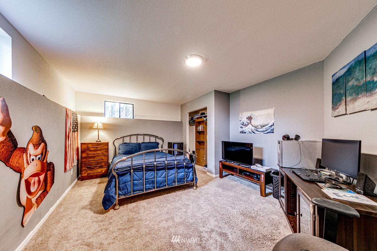 155 Taylor Cutoff Road Sequim, WA 98382 - Photo 19 of 37 a bedroom with furniture and a fireplace