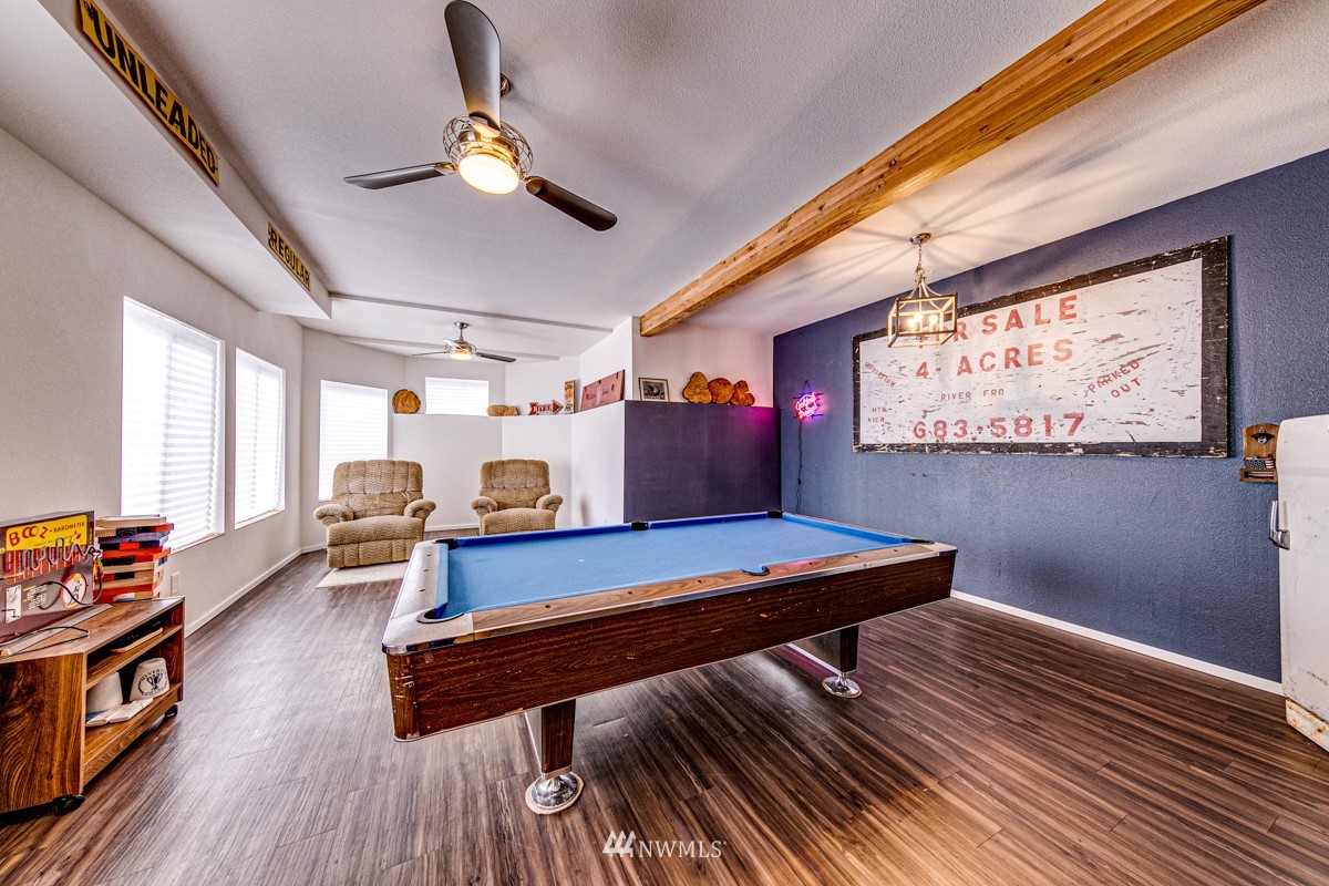 155 Taylor Cutoff Road Sequim, WA 98382 - Photo 23 of 37 a room with wooden floor pool table and windows