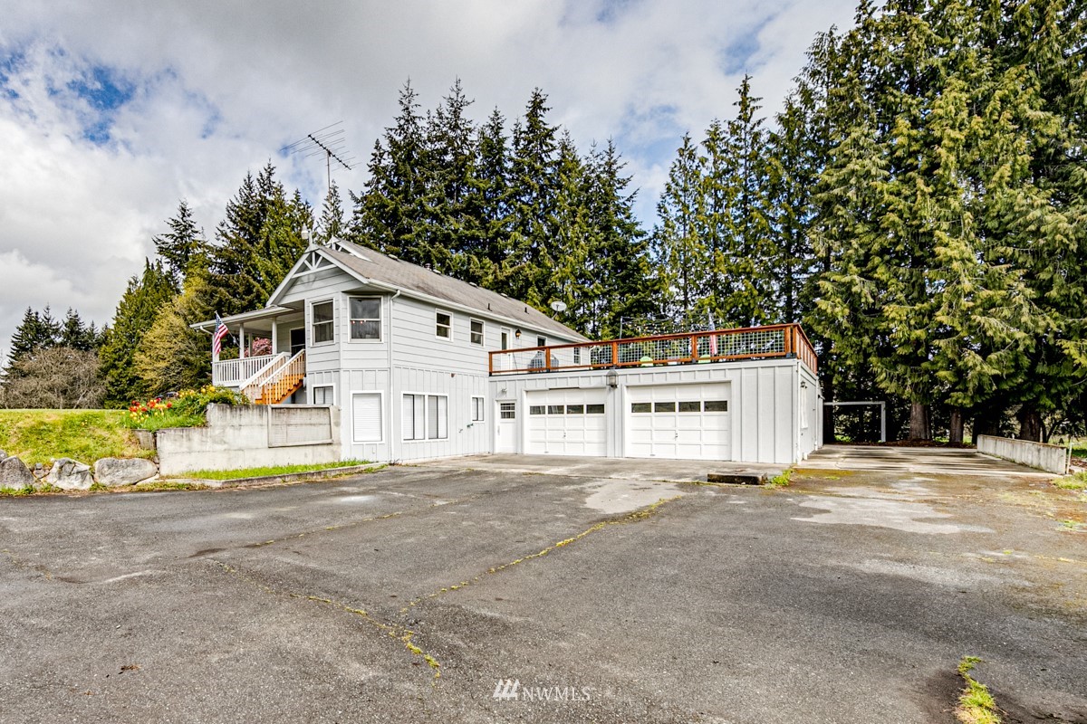 155 Taylor Cutoff Road Sequim, WA 98382 - Photo 27 of 37 a white house with a large tree in front of it