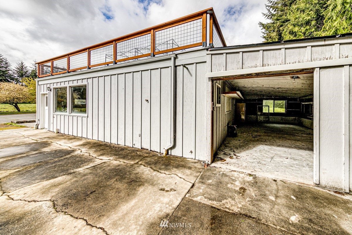 155 Taylor Cutoff Road Sequim, WA 98382 - Photo 29 of 37 a view of a house with wooden wall and roof
