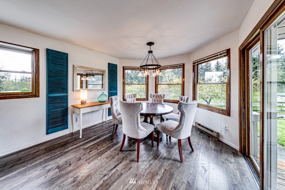 155 Taylor Cutoff Road Sequim, WA 98382 - Photo 8 of 37 a view of a dining room with furniture window and wooden floor