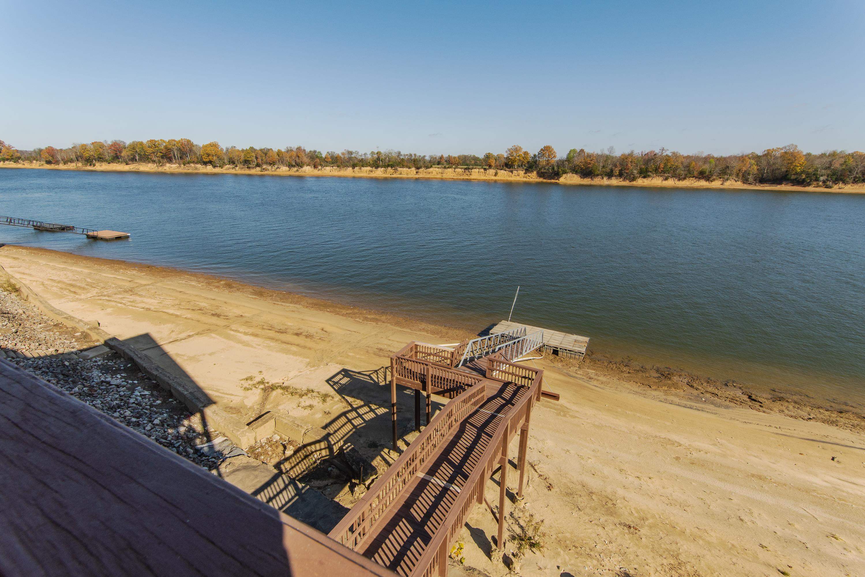 1111 Leaning Trees Lane Adamsville, TN 38310 - Photo 35 of 36 Waterfront property featuring extensive wood decking and stairs leading to a private dock