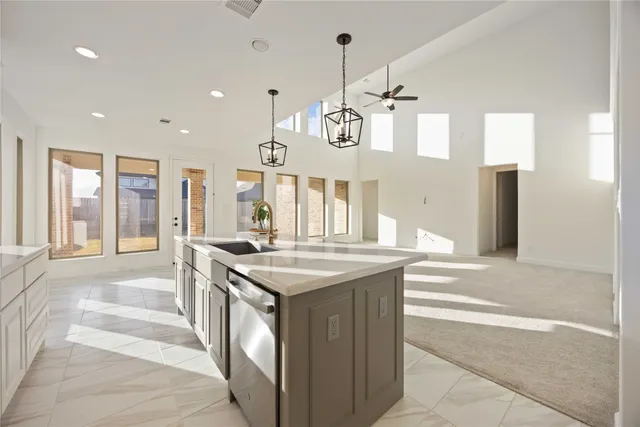 a kitchen with a stove and a view of living room
